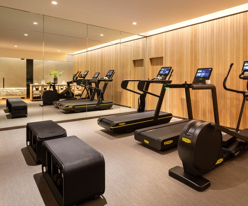 Modern fitness center with treadmills and workout equipment at Hotel Jackson spa in Jackson Hole