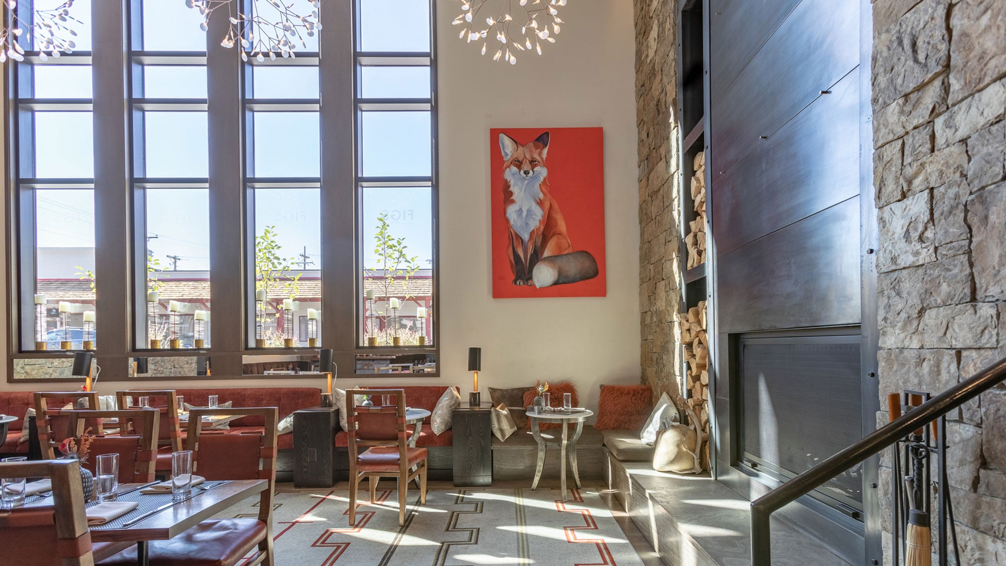 FIGS restaurant dining room at Hotel Jackson with stone fireplace and Western artwork