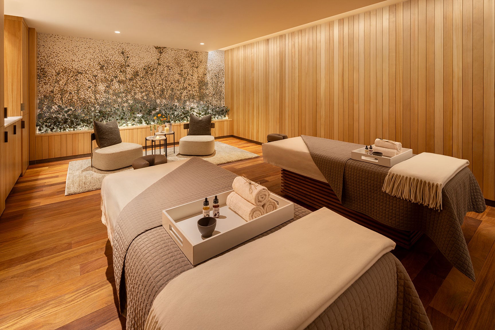 Private spa treatment room at Hotel Jackson with two massage tables and warm wood finishes
