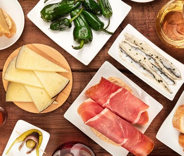 Seasonal share plates of cheese, cured meats and peppers
